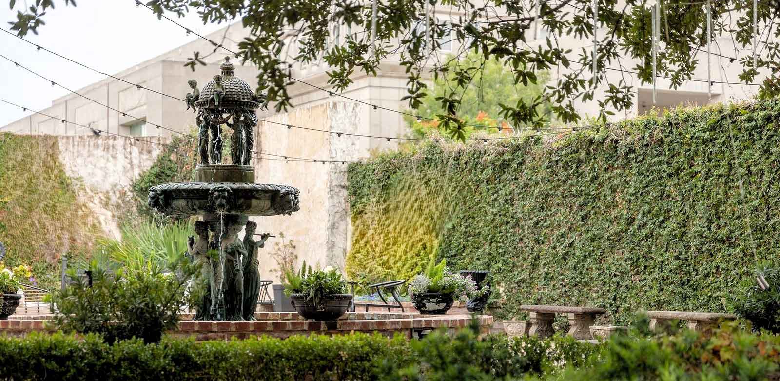 Photo of a courtyard fountain surrounded by greenery