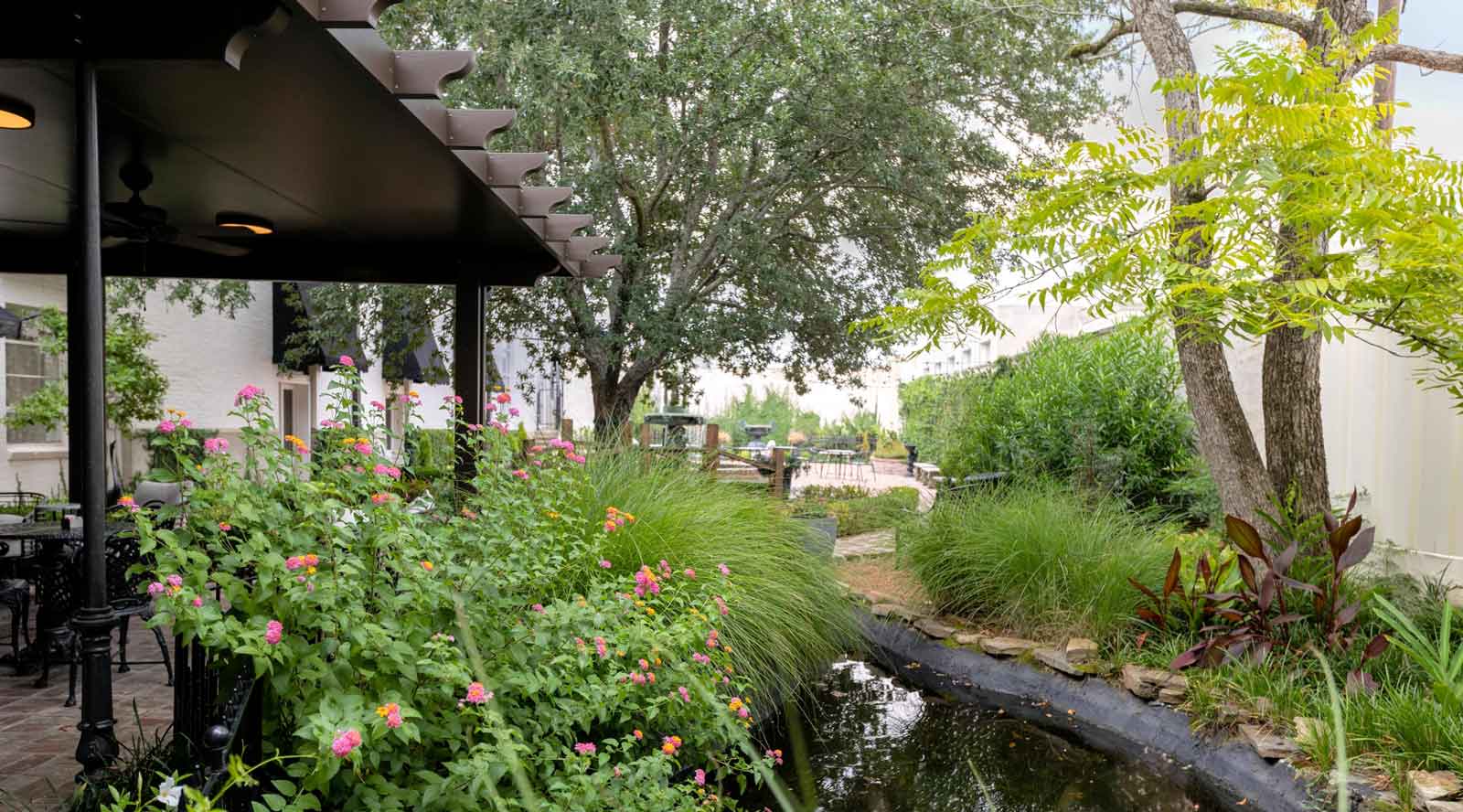 Photo of sunroom and covered, outdoor dining with garden and Koi pond