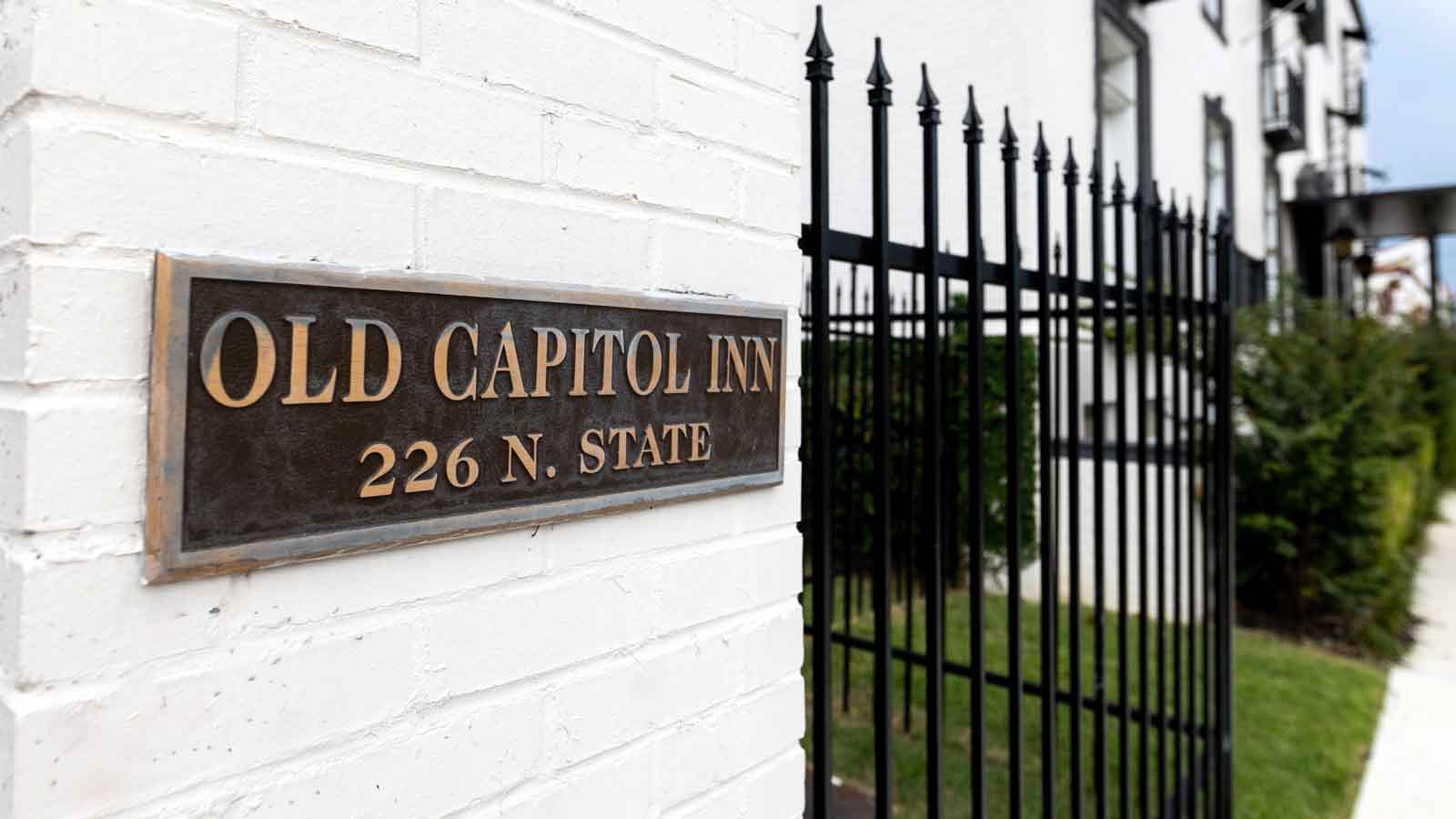 Photo of plaque on front of hotel that says, Old Capitol Inn, 226 N. State