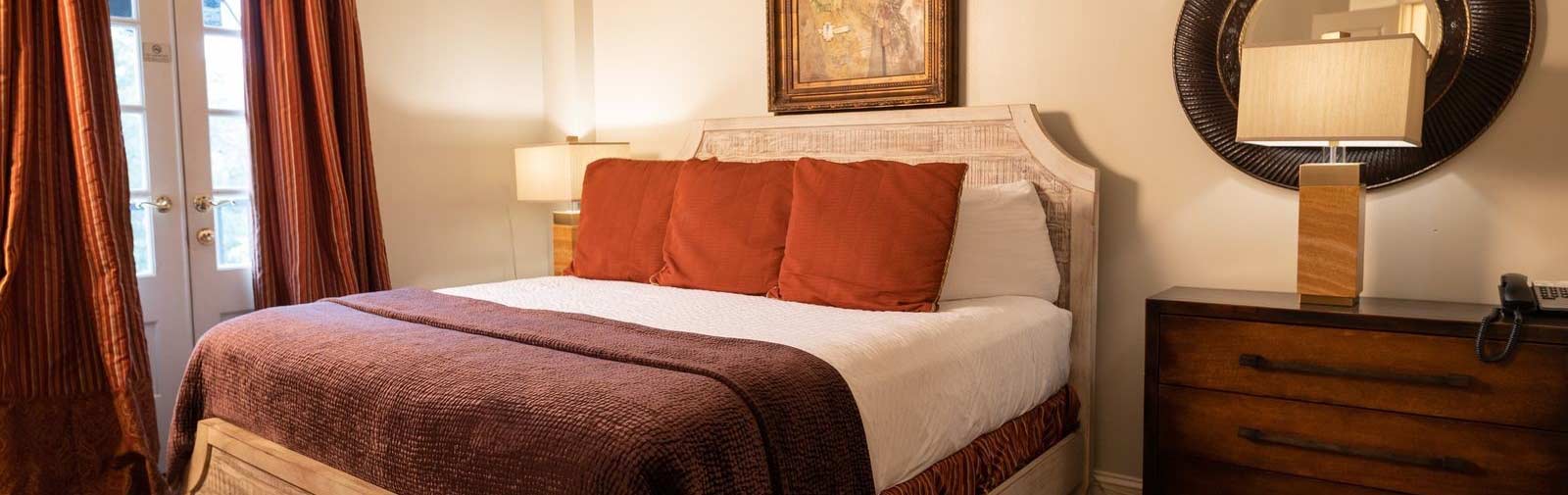 Photo of a bedroom in the Old Capitol Inn with french doors to the balcony