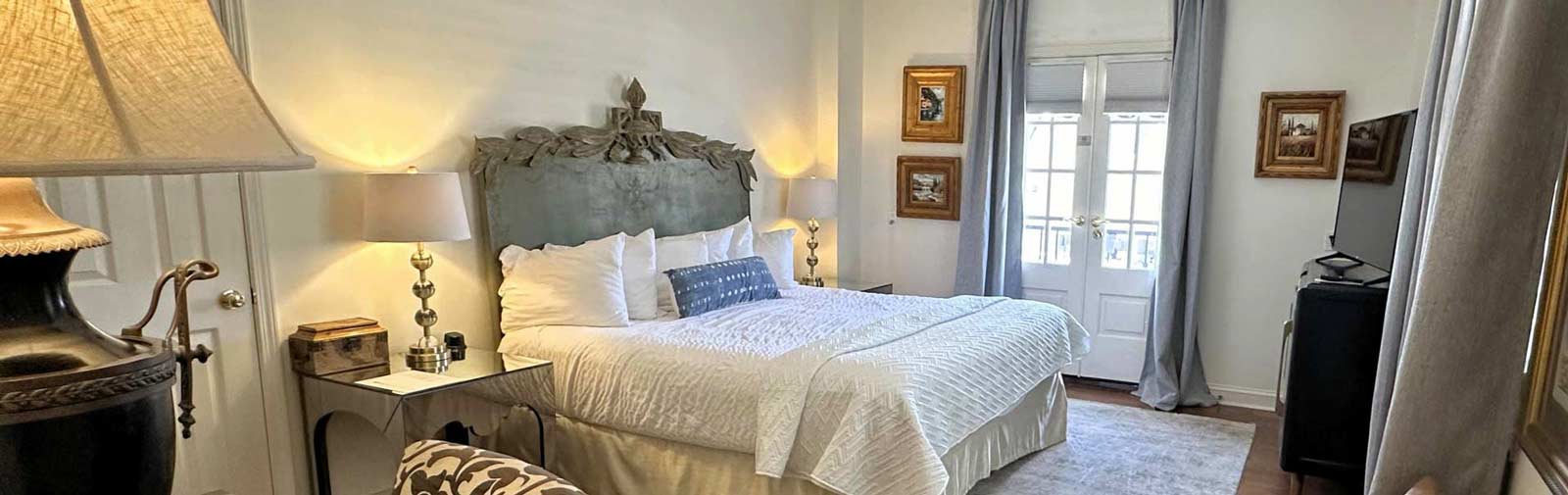 Photo of a bedroom in the Old Capitol Inn with french doors to the balcony