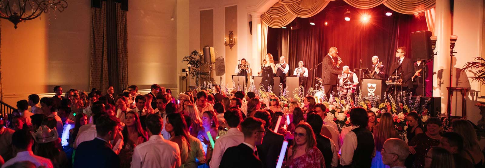 Photo of the Ballroom at the Old Capitol Inn with a live band playing and people dancing