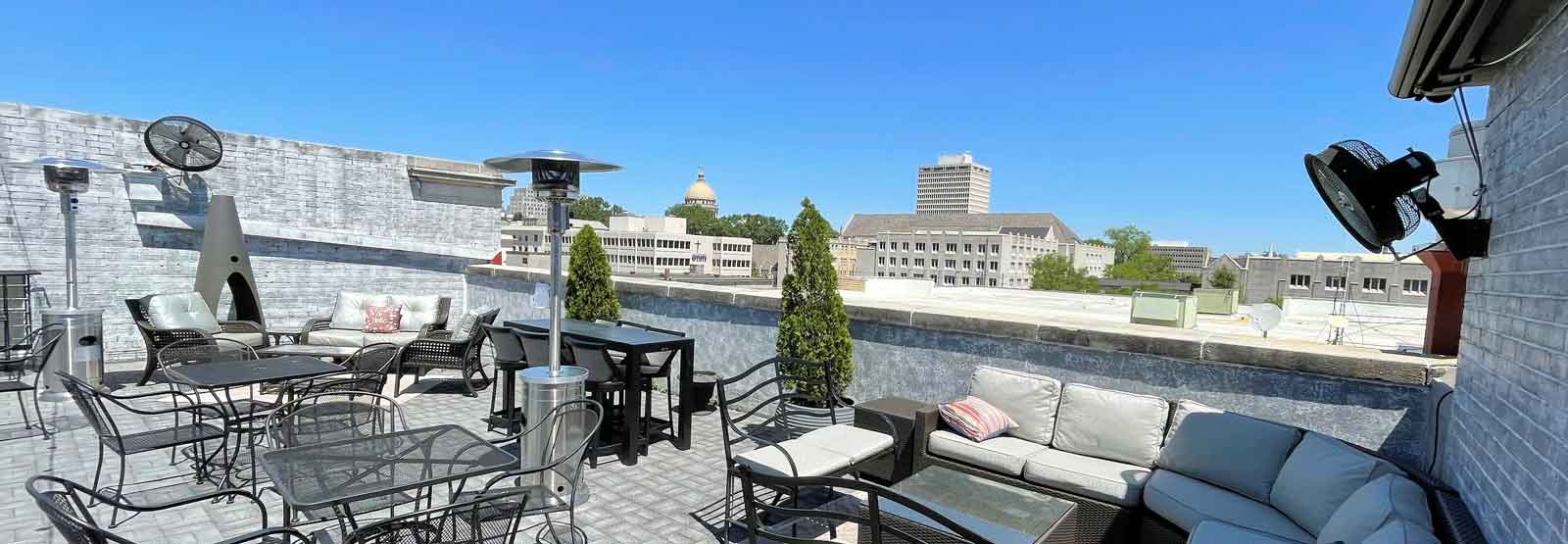 Photo of the Rooftop Bar at the Old Capitol Inn with a sunny view of downtown Jackson, MS